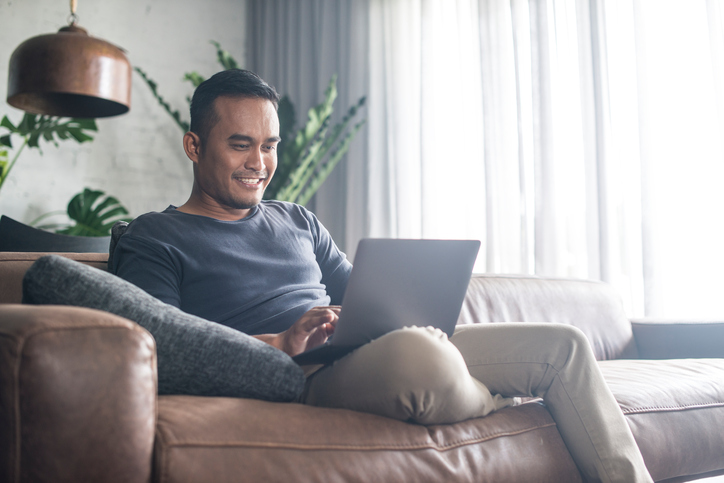 Young Asian man working at home.