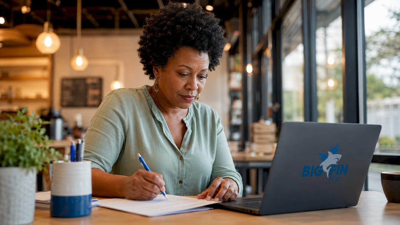 Business owner updating website at home desk
