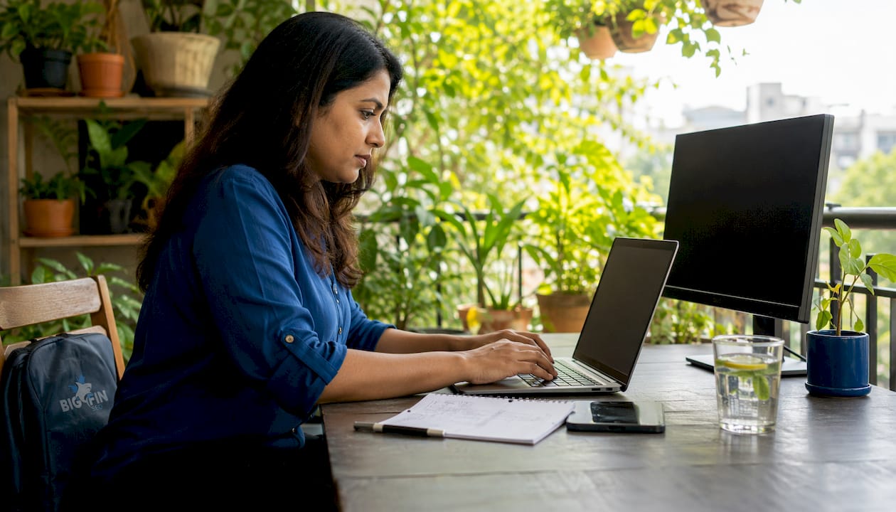 SEO professional working on laptop at desk
